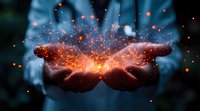 Glowing orange particles and light network floating above cupped hands against dark background, representing digital transformation and connectivity concept.