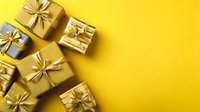 Golden gift boxes with shiny bows arranged on vibrant yellow background with copy space for holiday, celebration, or shopping concept.