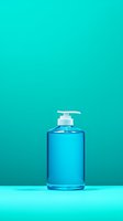 Blue hand sanitizer pump bottle on turquoise background for hygiene and healthcare concepts with copy space for text and design elements.