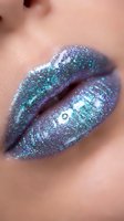 Close-up of lips with iridescent purple and teal glitter makeup, showcasing shimmer cosmetics for beauty and makeup artistry projects.