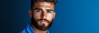 Professional young Caucasian businessman with beard in blue suit against gradient background for corporate marketing and business presentations.