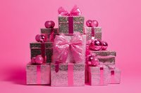 Stacked glitter gift boxes with pink bows and ornaments on pink background. Perfect for holiday, celebration, and festive design projects.