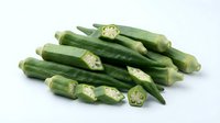 Fresh green okra pods with sliced pieces showing seeds, healthy organic vegetable ingredient for cooking and nutrition on white background.