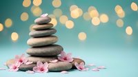 Zen stone stack with pink cherry blossoms and golden bokeh lights on turquoise background for spa wellness meditation and mindfulness concepts.