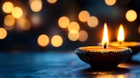 Traditional oil lamp with twin flames glowing against warm bokeh lights background creating peaceful ambiance for meditation and spiritual practices.