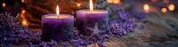 Purple aromatic candles with dried lavender flowers on rustic wooden surface, warm glowing bokeh lights creating peaceful spa atmosphere.