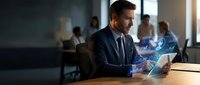 Professional businessman analyzing digital data analytics on laptop with holographic charts and graphs in modern office environment for business intelligence.