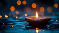 Traditional oil lamp with glowing flame floating on water surface with warm bokeh lights creating peaceful spiritual atmosphere for meditation and relaxation.