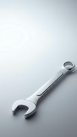 Chrome combination wrench tool on clean white surface for mechanical repair work and automotive maintenance projects.