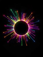 Vibrant multicolored neon light rays burst outward in circular pattern against black background, creating dynamic starburst effect for modern design projects.