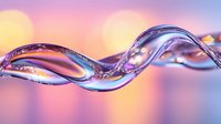 Flowing liquid glass or crystal wave with purple and pink reflections on blurred bokeh background creates elegant abstract macro composition.