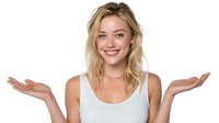Young blonde Caucasian woman with bright smile gesturing with open palms in welcoming pose on white background isolated for design and marketing use.