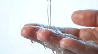 Clean fresh water flowing through cupped hands against white background. Hygiene, purity, wellness and environmental conservation concept for health campaigns.