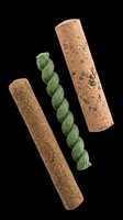 Three natural dog chew sticks isolated on transparent background, including twisted green, plain brown, and speckled varieties, for pet product clipart and print on demand.