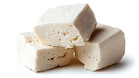 Fresh white feta cheese blocks with crumbly texture isolated on white background for culinary and cooking projects.