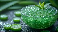 Fresh green cocktail with cucumber slices and mint garnish on dark surface with water drops, sparkling bubbles create refreshing summer drink appearance.