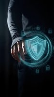 Businessman hand touching glowing digital shield icon with circuit patterns and lock symbols representing cybersecurity protection and data safety technology.