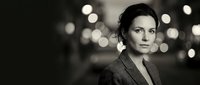 Professional businesswoman in suit with bokeh lights background for corporate presentations and marketing materials.