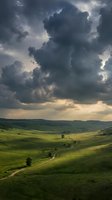 Dramatic storm clouds loom over rolling green hills with winding dirt road, perfect for weather, landscape, and nature backgrounds.