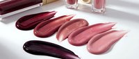 Cosmetic lipstick swatches in burgundy pink nude shades on white background for makeup beauty product advertising and branding materials.