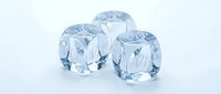 Three crystal clear ice cubes with realistic reflections and transparency effects on white background for beverage and cooling concepts.