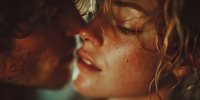 Young couple sharing intimate moment with warm golden lighting and soft focus romantic atmosphere for wedding or love themed projects.