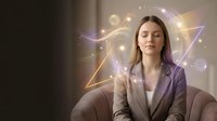 Caucasian woman in business attire surrounded by glowing geometric shapes and light effects, representing innovation and creative thinking for corporate concepts.