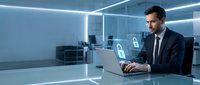 Professional businessman working on laptop with digital security icons in modern blue-lit office environment for cybersecurity and data protection concepts.
