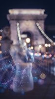 Double-exposure nighttime cityscape featuring an iconic bridge with glowing bokeh lights and ethereal particle effects overlaid with architectural elements for travel and urban design projects.