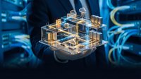 Businessman holding holographic smart city model with glowing buildings and digital connections for urban planning and technology innovation concepts.