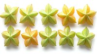 Starfruit slices arranged in two neat rows showing gradient from yellow to green on white background, fresh tropical carambola cross sections for food design.