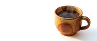 Rustic ceramic cup filled with dark coffee or tea, featuring warm brown and golden tones with aged patina, isolated on white background for beverage and kitchenware design projects.