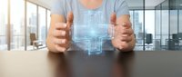 Businessman hands protecting holographic digital technology interface in modern office environment for innovation and data security concepts.