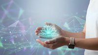 Hands holding glowing digital lotus flower with network connections and geometric patterns representing technology, innovation and digital transformation concepts.