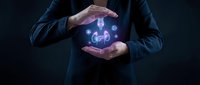 Businessman hands protecting glowing human figure with network connections symbolizing employee care, HR management, and corporate responsibility concept.