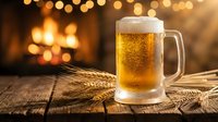 Fresh golden beer mug with foam on rustic wooden table with wheat stalks and warm bokeh lights creating cozy pub atmosphere for beverage advertising.