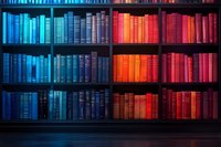 Dramatic bookshelf with gradient lighting effect from cool blue to warm red tones illuminating rows of vintage hardcover books on dark wooden shelves.