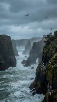 Dramatic coastal cliffs with seabirds flying over turbulent ocean waves under stormy gray sky creating moody seascape for nature photography and travel content.
