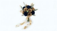 Elegant wedding bouquet with navy blue and gold roses tied with cream ribbon on white background for bridal photography and romantic celebrations.