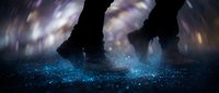 Person walking through glowing blue particles with motion blur effect creating magical atmosphere for fantasy and sci-fi projects.