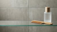 Wooden comb and frosted glass cosmetic bottle with gold cap on green shelf against gray tile wall background for beauty and personal care product display.