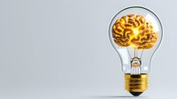 Glowing golden brain inside light bulb on gray background, creative thinking and innovation concept for business solutions and ideas.