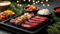 Raw and grilled meat steaks on black grill pan with rice, vegetables and sauces. Festive table setting with bokeh lights and pine branches. Food photography.
