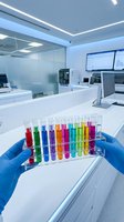 Scientist in blue latex gloves holding rack of colorful liquid samples in modern laboratory with white countertops, glass partitions, and digital displays for research and chemical analysis.