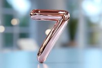 Metallic rose gold number seven floating against blurred background with bokeh effect, modern minimalist design for counting and numerical presentation.