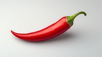 Fresh red chili pepper with green stem isolated on light gray background, sharp detailed macro photography showing glossy texture and natural curves.