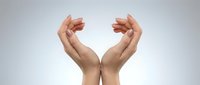 Two open hands positioned upward in protective caring gesture on clean white background isolated for design concepts and presentations.