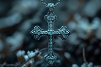Ornate silver cross pendant with intricate floral details and gemstone accents hanging on chain against dark blurred background, spiritual jewelry photography.