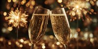 Two champagne flutes clinking together with sparkling wine against blurred background of festive sparklers and bokeh lights for celebration.