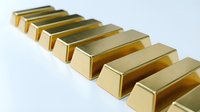 Row of shiny golden bars arranged in perspective on white background representing wealth investment and financial security for business concepts.